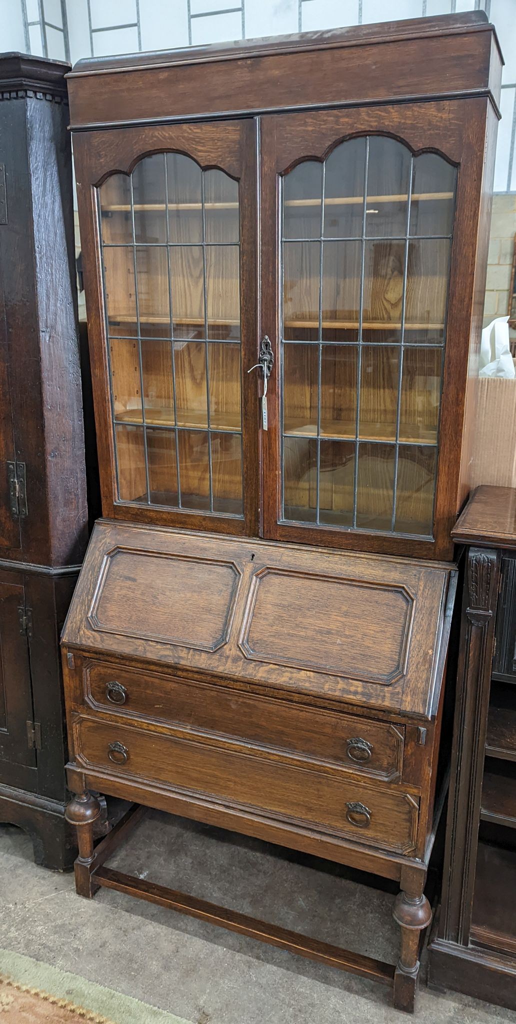 A 1920's oak glazed bureau bookcase, width 88cm, depth 42cm, height 200cm